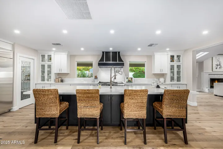 The newly remodeled kitchen features an oversized island that provides seating, workspace, and storage.