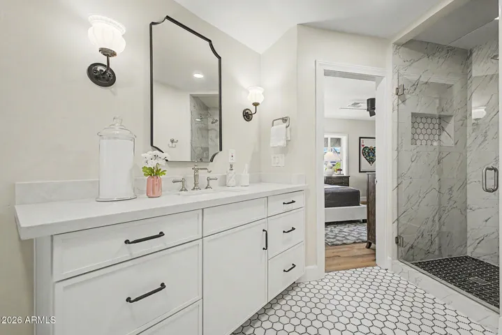 The jack & jill bathroom features a step in shower, bathtub, large vanity, retro fixtures, and natural light.