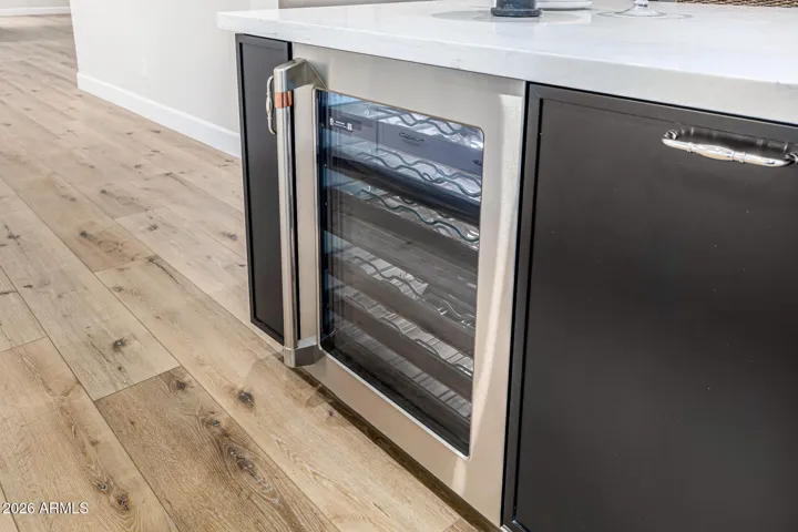 GE Cafe appliances round out the luxury kitchen and include a refrigerator for wine enthusiasts.