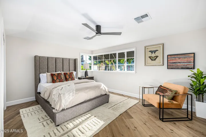 Bedroom 3 features this gorgeous corner window shaded by an awning and trees.