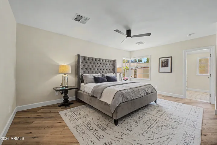 The primary suite is roomy and bright with a corner window view to the back yard.