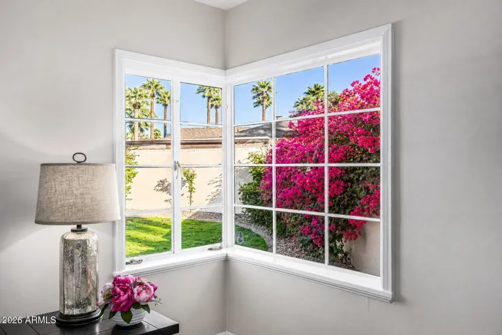 The Primary Bedroom features this gorgeous corner window with a view to the lush back yard. (Bouganvillia is planted but not quite this tall yet. Shown here as a virtual rendering.)