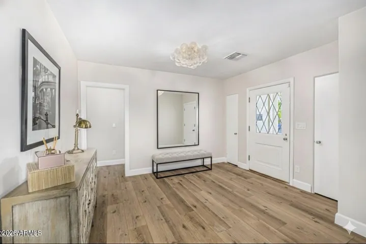 The original front door has been preserved to welcome you into an open foyer with fabulous bubble light fixture.