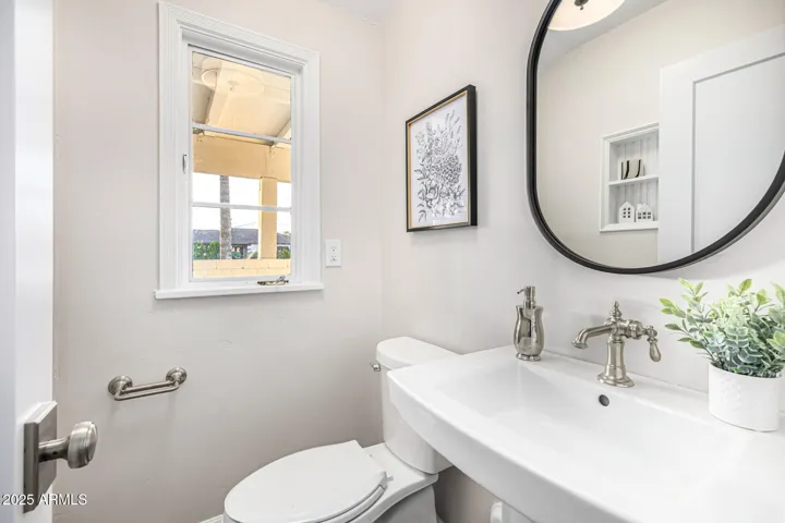 The "tuxedo bath" (named for it's black-banded light shade) is a charming powder room conveniently located off the garage entry and kitchen.