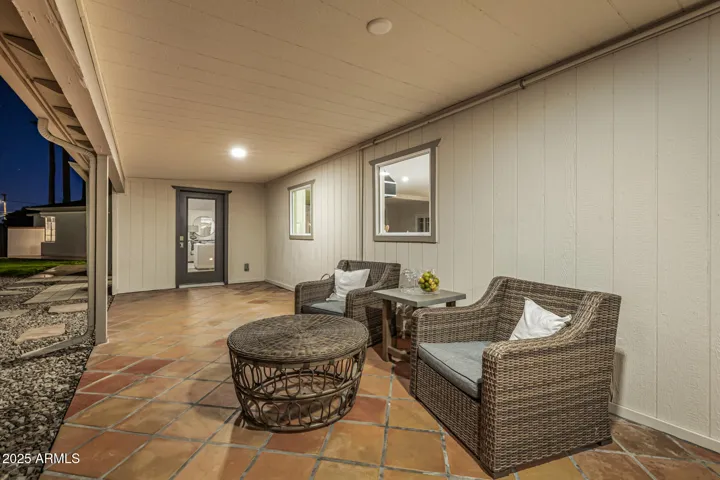 An extended covered patio runs behind the home, offering a shady space for an evening refreshment!
