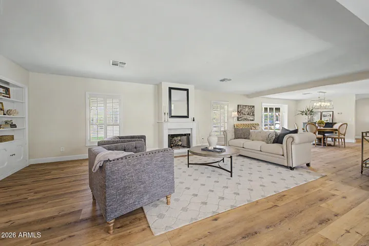The sitting room has been modernized with an open flow to the dining room and island kitchen.