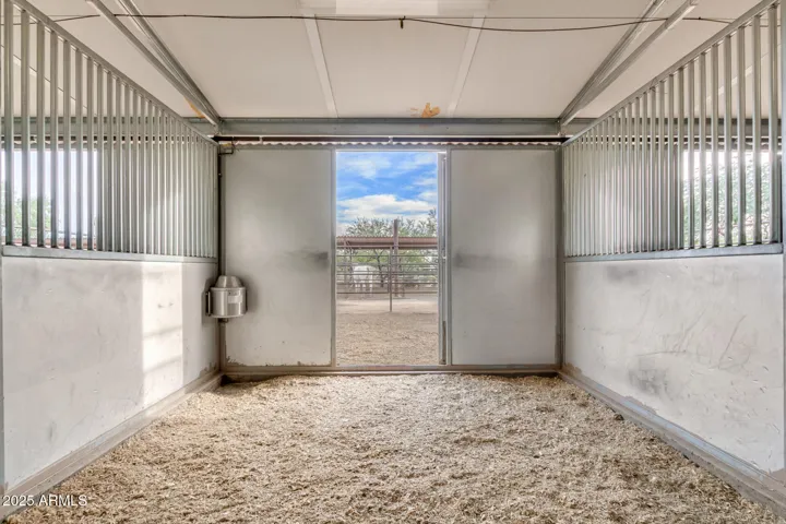 Matted stall with shavings and Nelson auto waterers