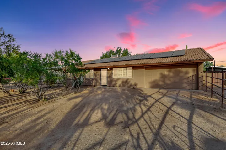 Front of property - Twilight - view of owned solar panels