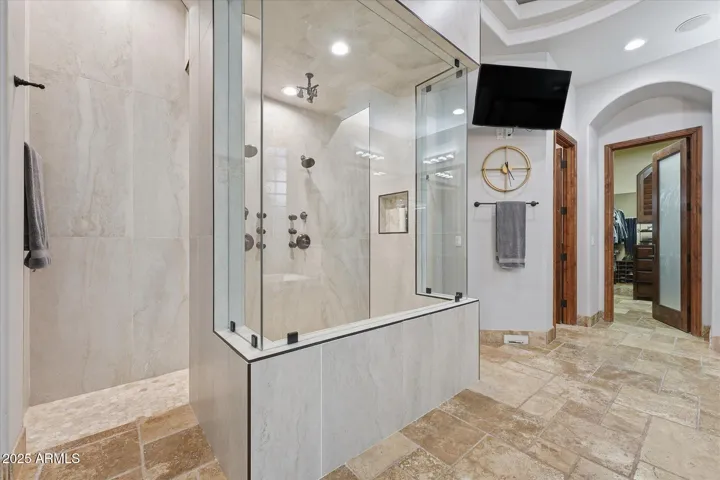 Walk-through shower with 9 shower heads.