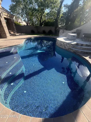 The whole pool is a beautiful glass tile blue.