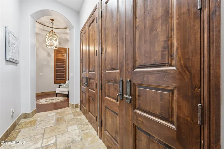 Owners suite hallway with extra storage closets.