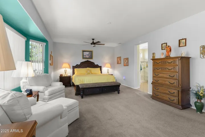 Primary bedroom from far left corner outside of bay window sitting area