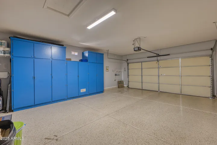 Extended 2 car garage w epoxy flooring and painted storage cabinets