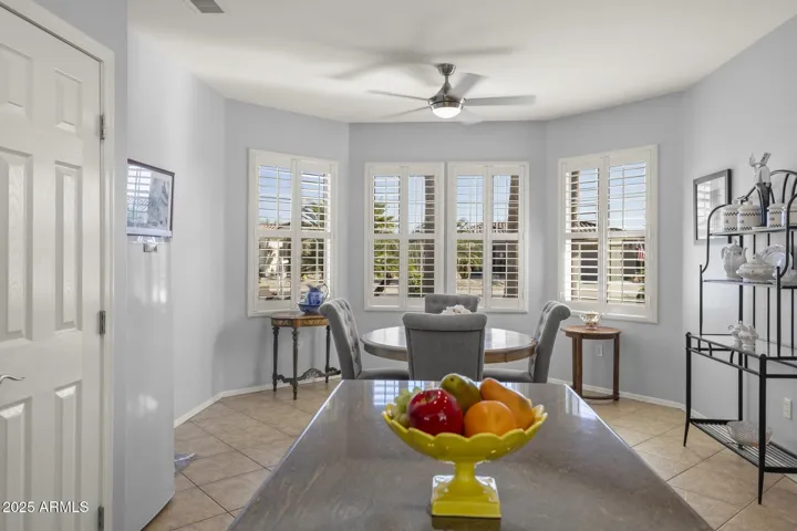 Kitchen from sink side showing island, pantry to the left and the large bay window dining nook