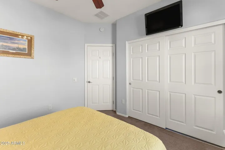 Guest bedroom toward closet and door to hallway