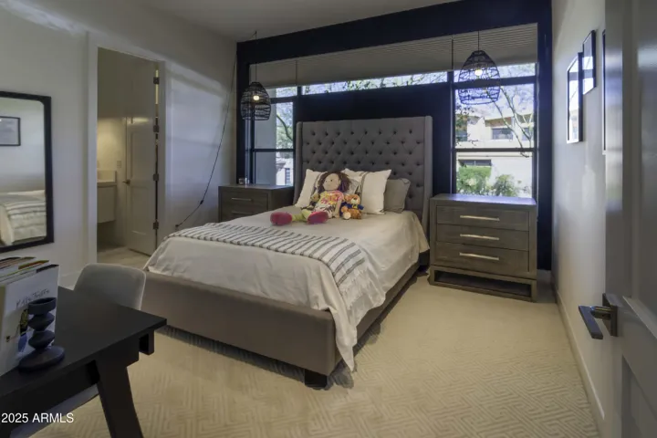Bedroom is ensuite, split from primary bedroom and adjacent to family room
