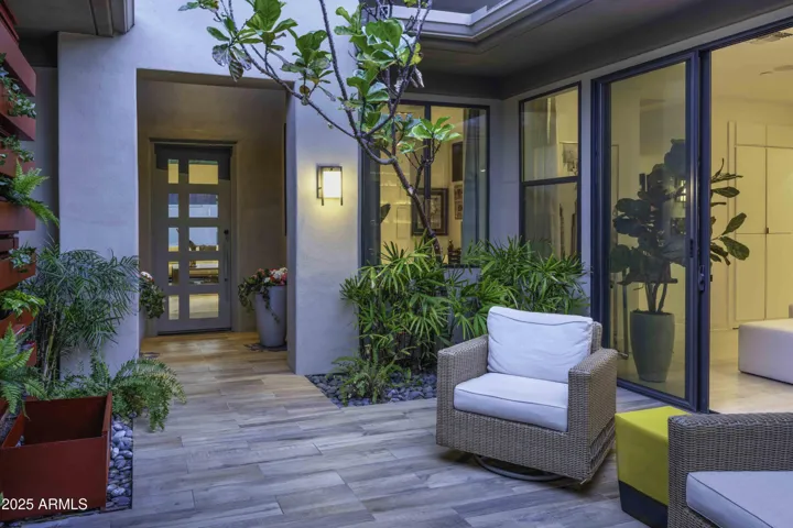 Courtyard features living plant wall and big screen tv.