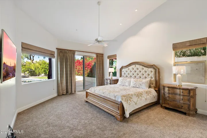 Master Bedroom complete with Restoration Hardward with 85 inch TV on the Wall and full view of rear yard.