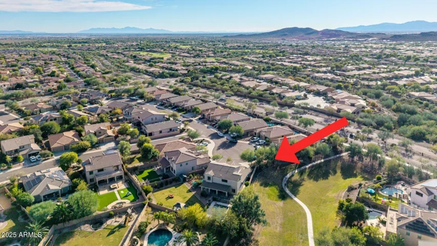 Aerial perspective showcasing the Peoria property backing to a greenbelt with walking paths, providing added privacy, outdoor access, and a desirable setting.