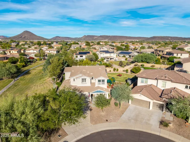 Elevated front view of the Peoria property with beautiful mountain backdrops, neighborhood layout, and nearby walking paths enhancing the location. Sits on a cul de sac lot