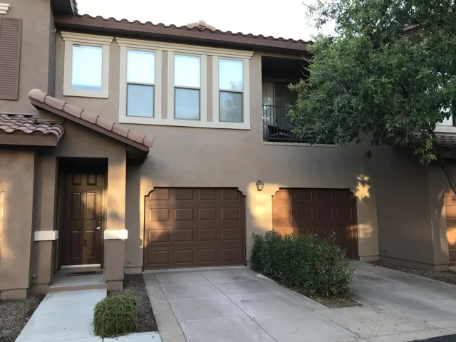 Front view of unit 2024. Front entrance is the door on the left and there is a tandem garage to the right with direct access to the unit