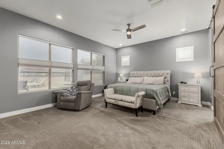 Primary Bedroom downstairs w/private exit to back yard/pool.