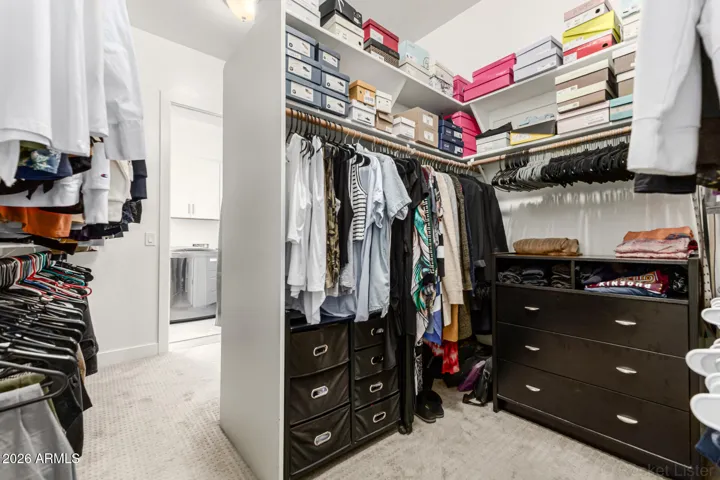 Primary bedroom closet walks through to laundry room.