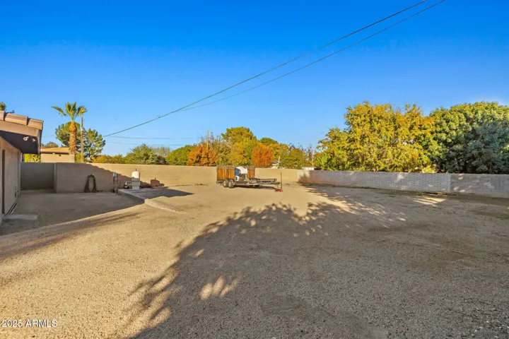Gravel back packing with RV sewer clean out, electric, and pool equipment