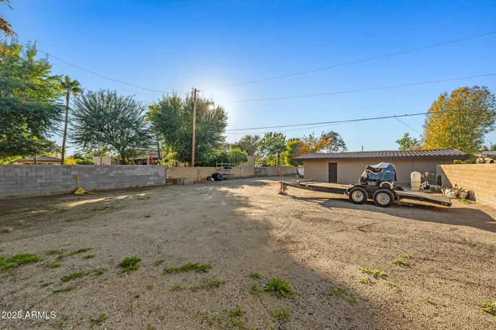 Gravel back packing with RV sewer clean out, electric, and pool equipment