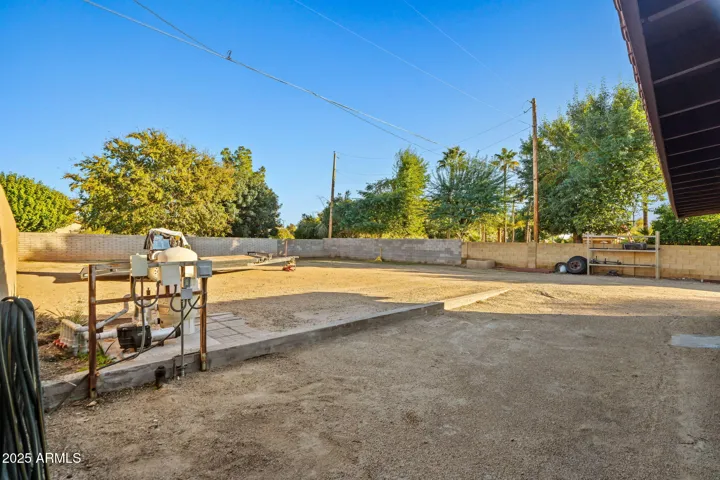 Gravel back packing with RV sewer clean out, electric, and pool equipment