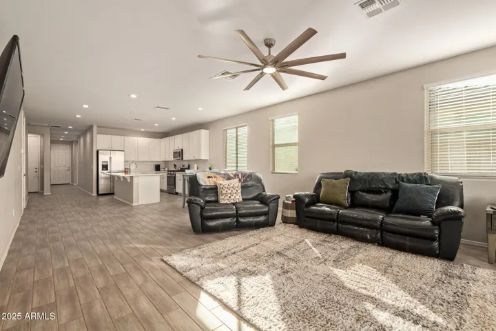 Wide-open layout connecting the great room and upgraded kitchen with quartz counters and stainless appliances. Designed for entertaining and everyday comfort in this Wittmann home.