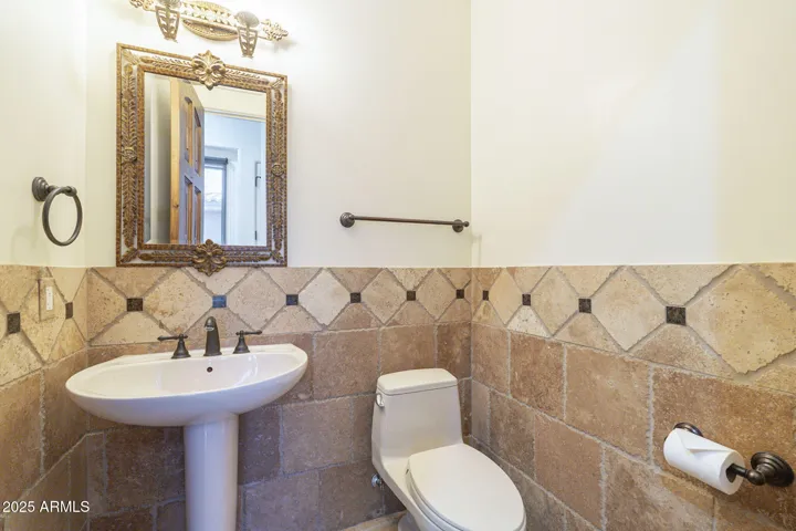 This half bath is just down the hall from the Kitchen area and convenient for any activities held in the courtyard as well as it is easily access through double doors leading to the courtyard.