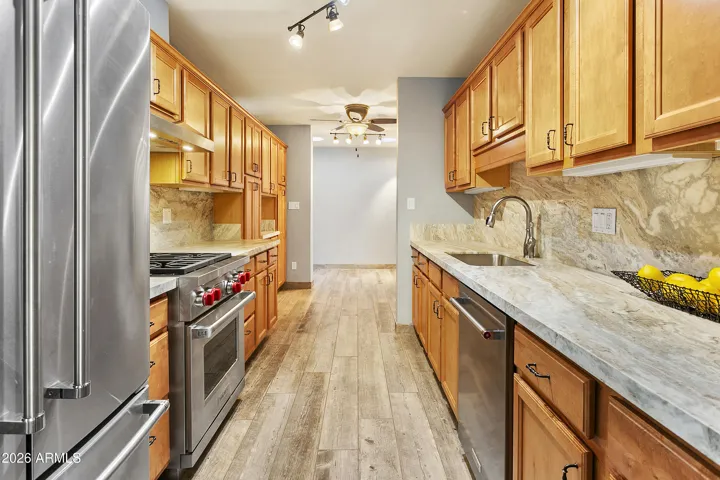 Kitchen with brushed marble countertops, Wolf gas range