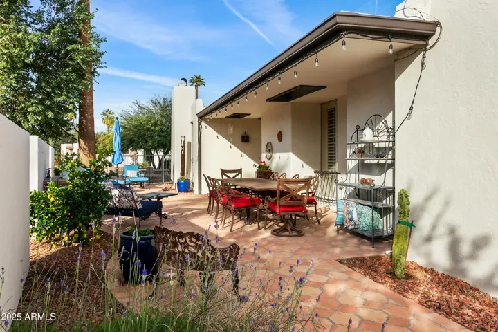 Welcoming private courtyard entry with terracotta paving and covered patio
