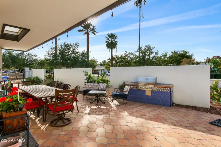 Welcoming private courtyard entry with terracotta paving and built-in gas barbecue