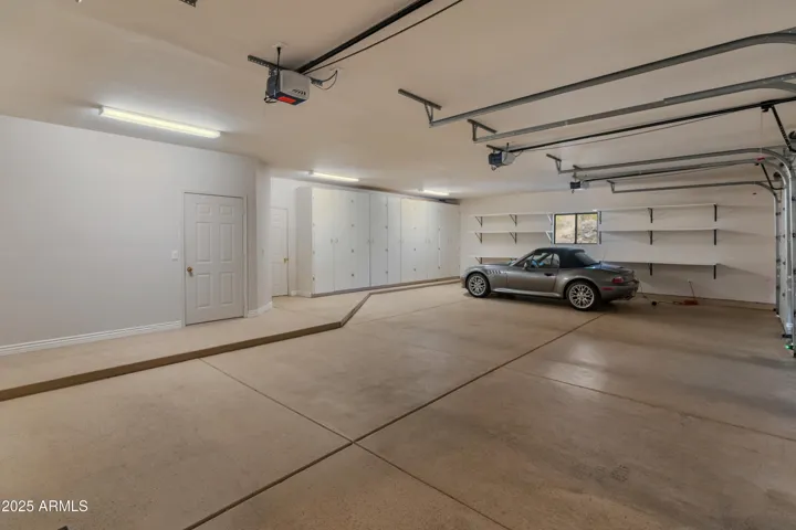 Three car garage with ample storage. BMW does not convey.