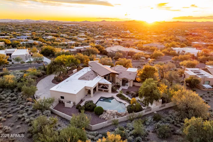 Aerial view of property facing sunset