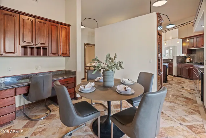 Breakfast nook featuring built-in cabinets and desk