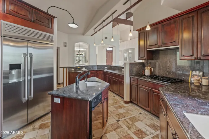 Kitchen featuring an island with sink