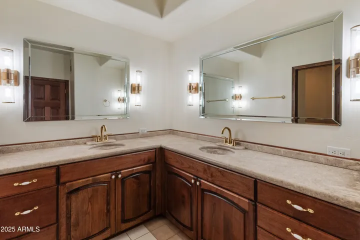 Hallway bathroom with dual sinks