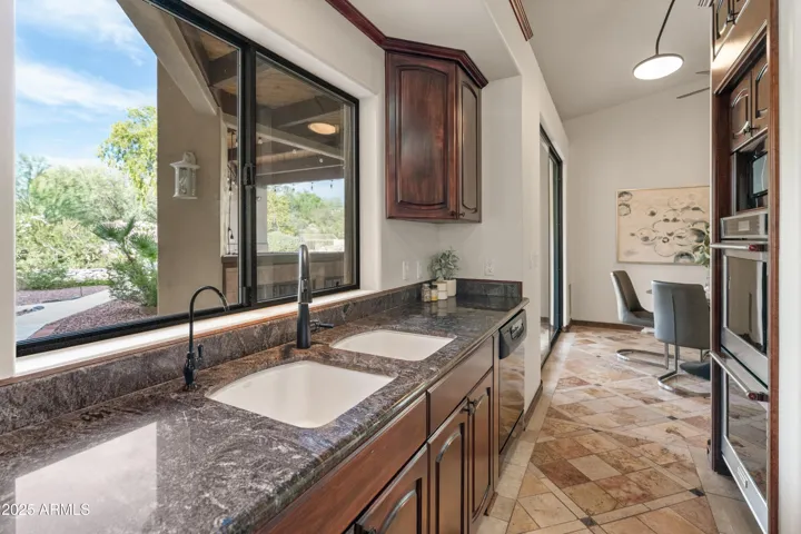 Kitchen sink featuring backyard view
