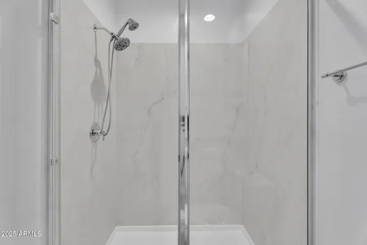 Glass shower located in the attached guest suite