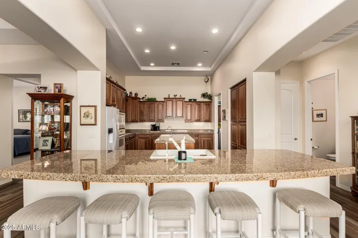 Spacious Kitchen Featuring a Large Seating Island Connecting Seamlessly to Living Room, Both Dining Areas, Laundry Room & Powder Room