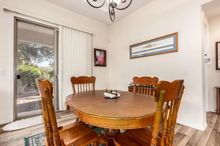 Dining Space off the kitchen, Patio Doors leading you to Brick Pavers under expansive covered patio Overlooking Mature Landscaping - Offering Abundant space for Entertaining & relaxing