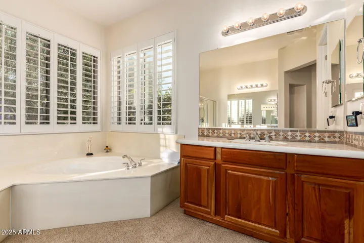Soothing the day away with the Luxurious Jetted Tub & added Privacy with the Shutter on the windows, Your very own Vanity Sink with Abundant Cabinet Space