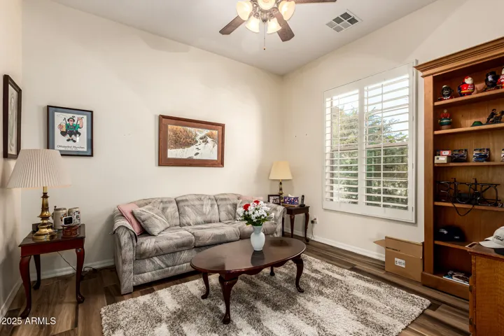Large Double Doors allows entrance to this Second Living Room, Second Office Space, or Third Bedroom located near the restroom, Shutters on the windows add privacy.