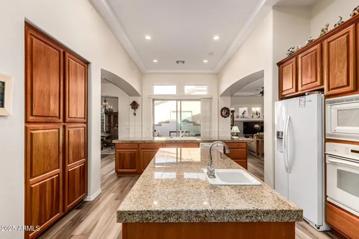 Pantry Wall, Built in Ovens, Prep Island, Main Island & Sink with Dishwasher over looking the Court Yard View from Oversized Sliding Doors