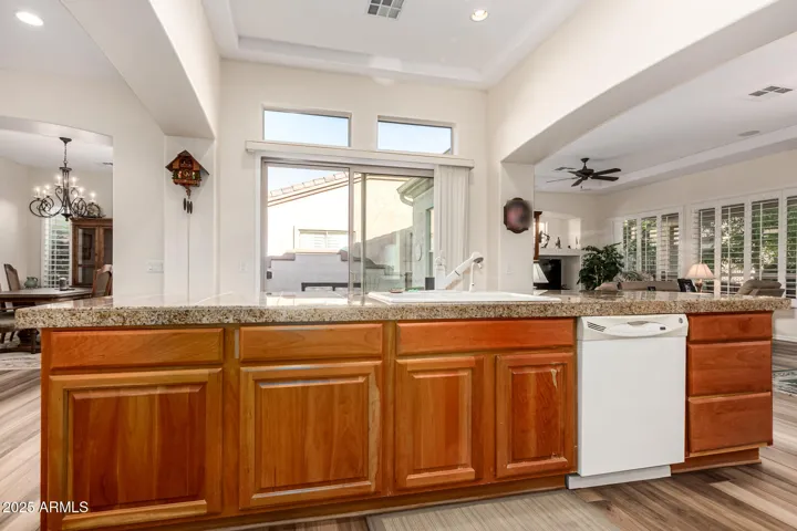 Main Kitchen Island with Sink, Dishwasher & seating for quick meal or snack while enjoying the Peaceful Garden Area View