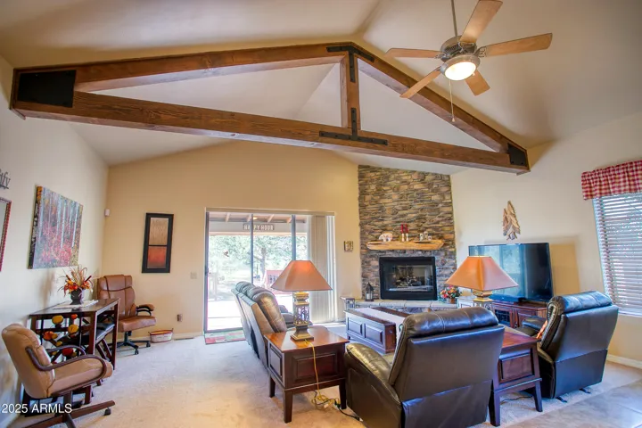 Large living area focuses on the stacked stone gas fireplace and the large slider that lets in the outdoors!