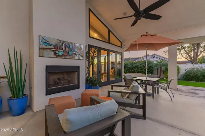 Extended outdoor living space with fireplace is a perfect setting for AZ winters!